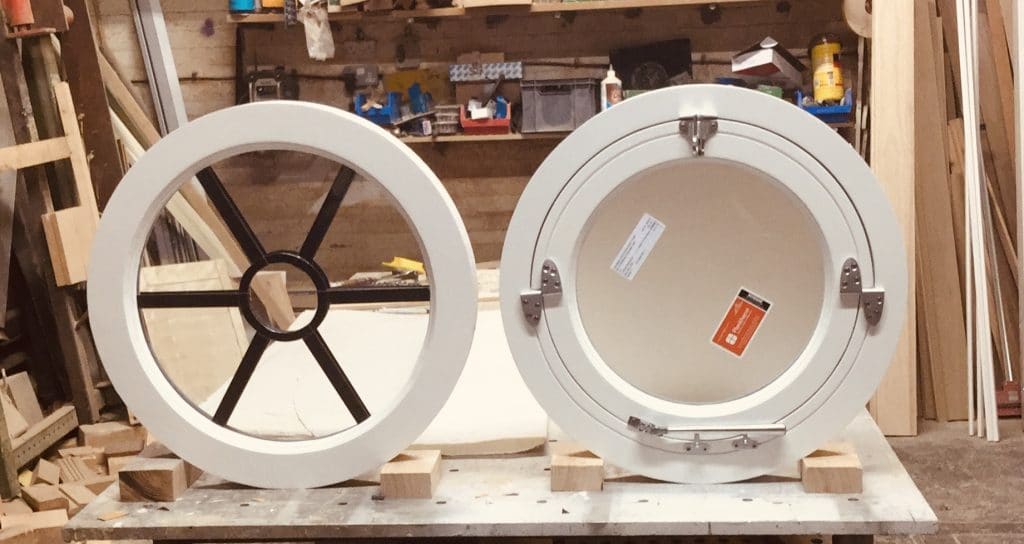 Round windows. One is fixed with clear toughened glass and one openable with obscured glass, special hinges to operate.